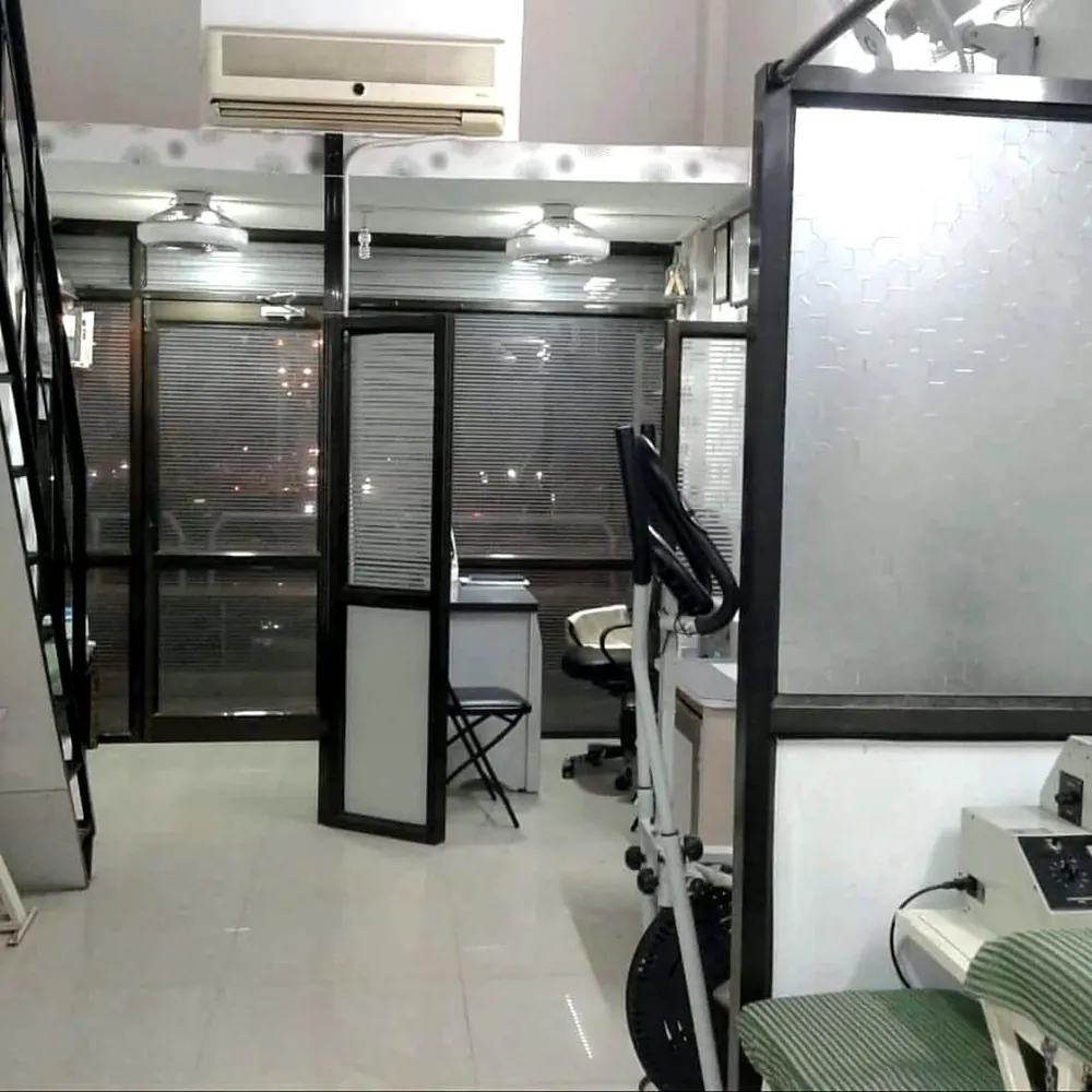 Inside Nisarg Physiotherapy Clinic: glass-walled treatment cabins and an exercise cycle
