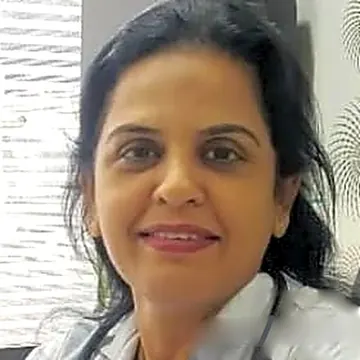 Dr. Hemal Gondkar, physiotherapist, in her white coat and stethoscope